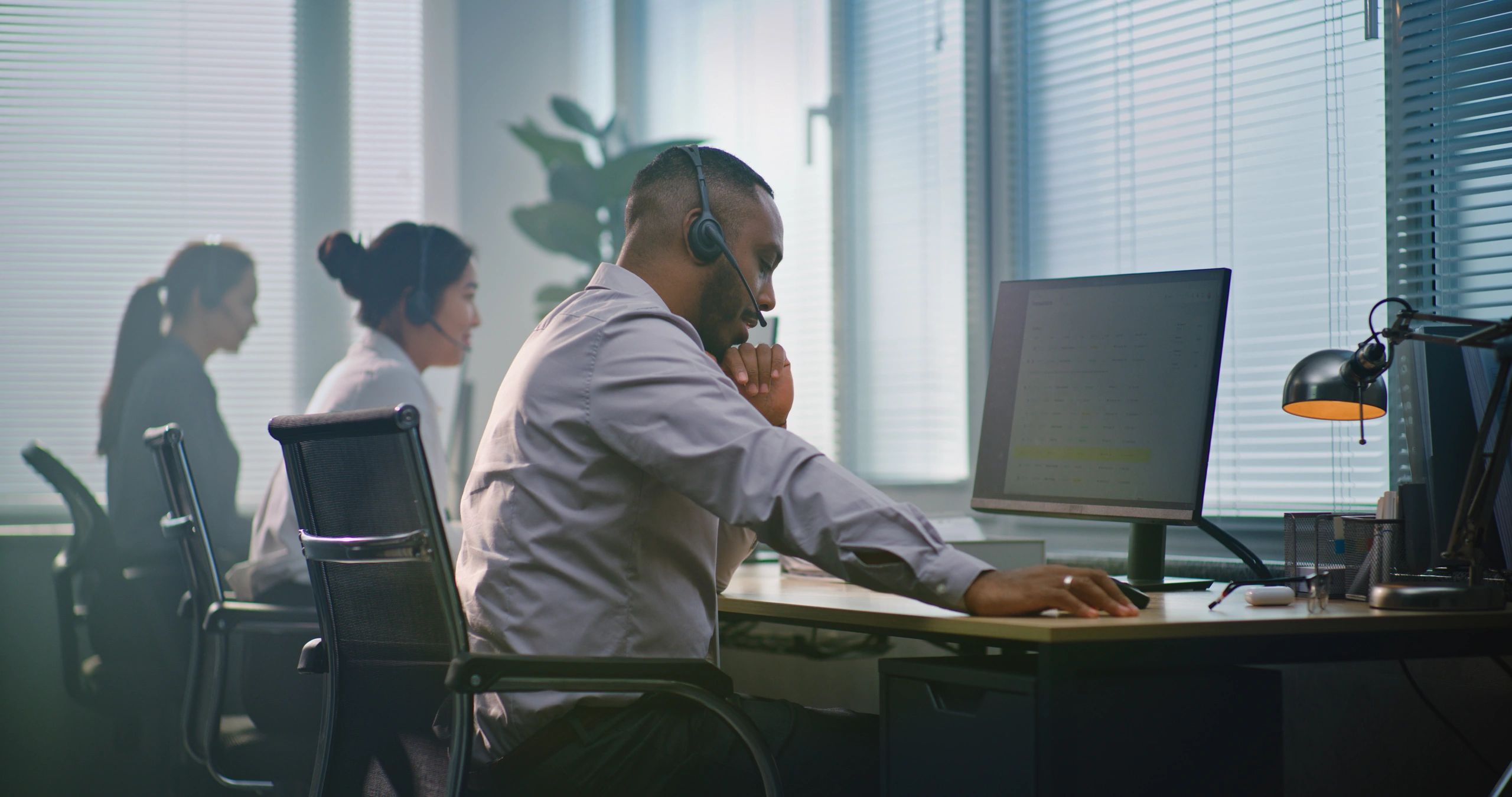 Help desk team providing support in a modern office
